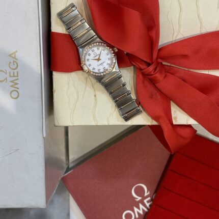 Omega Steel / 18K Yellow Gold Diamond Logo dial.